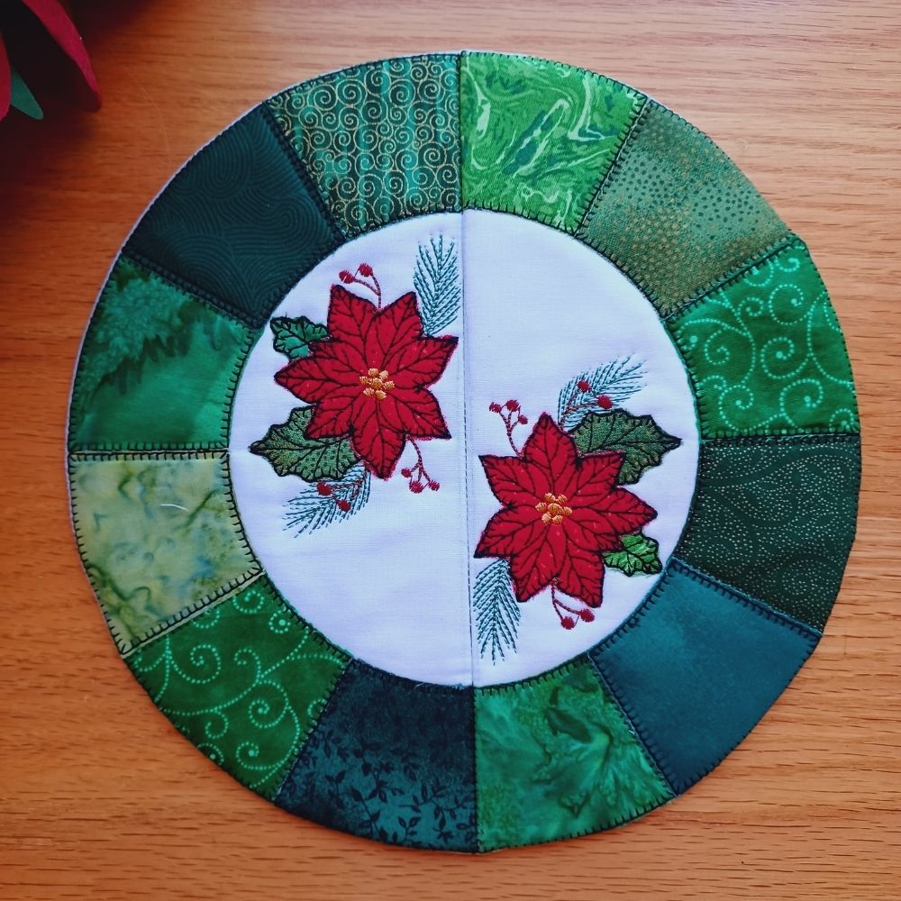 EW563 - ITH Applique Poinsettia Table Topper