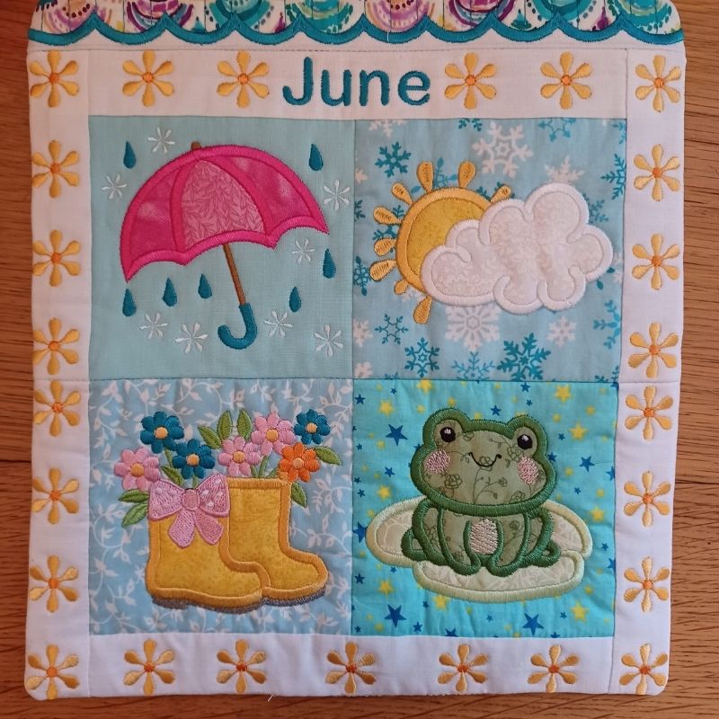 Close-up of ITH mini house quilt June embroidery design showing embroidery and appliqué details